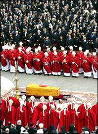 The cardinals surround the coffin