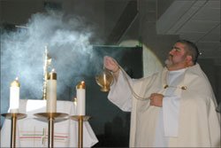 Priest incenses the altar